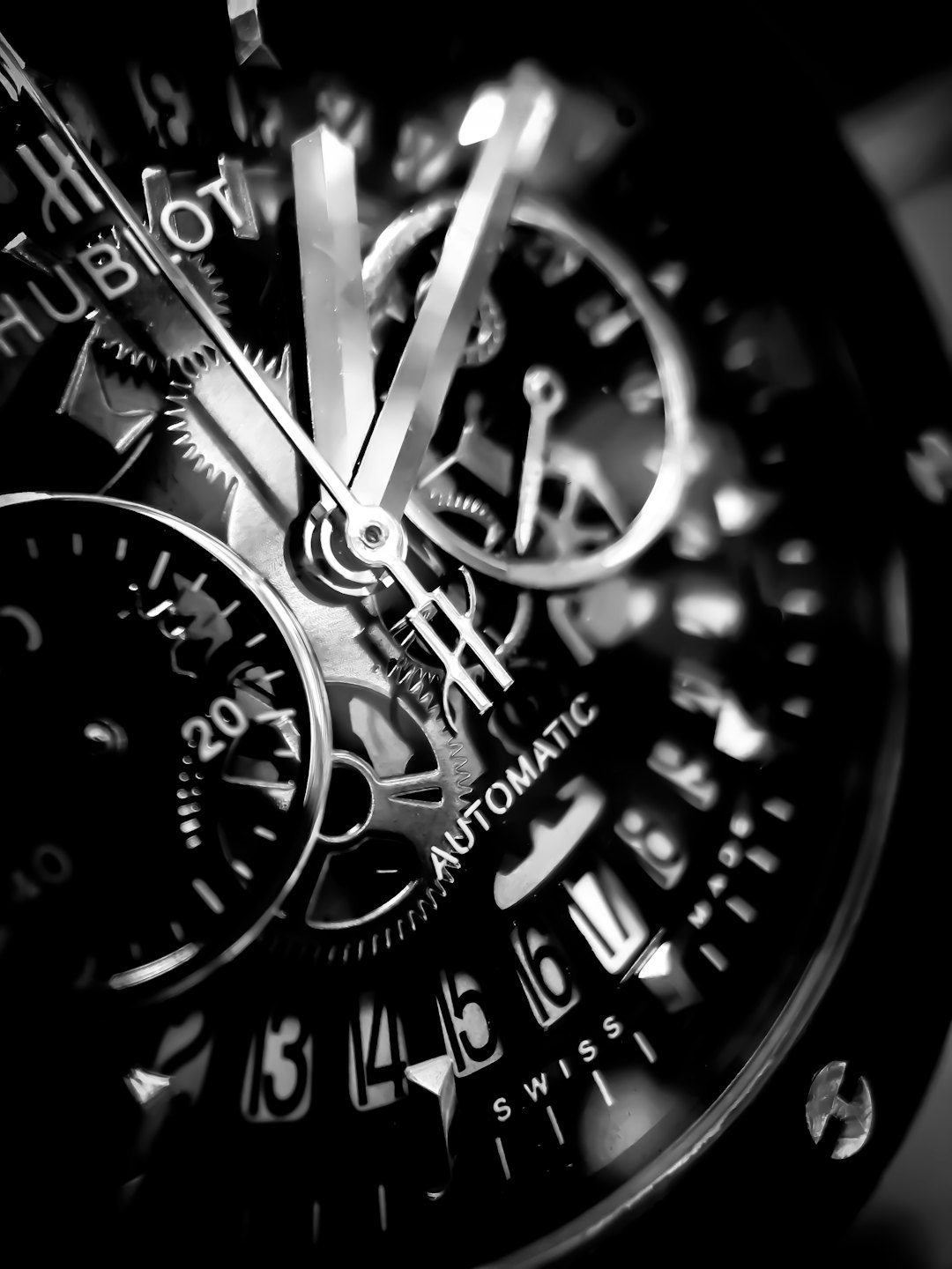 Intricate gears and hands inside a luxury automatic wristwatch.